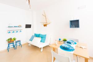 a living room with a table and chairs and a tv at Isola Blu in Taranto