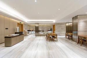 a kitchen and dining room with a table and chairs at JI Hotel Shanghai Changshou Road in Shanghai