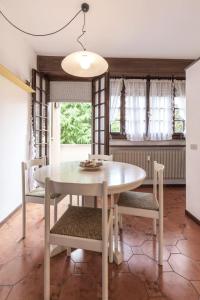 a dining room with a white table and chairs at Maison Leti Comfort Studio in Bellagio +8 photos