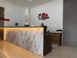 a restaurant with a counter with a sign on the wall at Hotel Seri Rembau in Rembau
