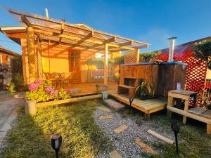 a backyard with a wooden pergola and a table at Casa Costa Ñuble in Cobquecura
