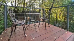 two chairs and a table on a deck at The Studio Suite at Villa 7 in Hepburn Springs