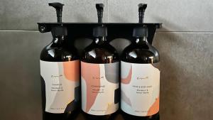 a group of three bottles of wine on a shelf at The Studio Suite at Villa 7 in Hepburn Springs