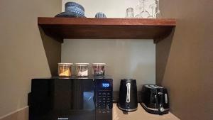 a microwave sitting on top of a kitchen counter at The Studio Suite at Villa 7 in Hepburn Springs