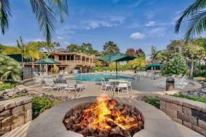 a fire pit in front of a swimming pool with a resort at Luxury Condo Resort Amenities - Pool, Pickleball in San Diego