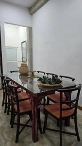 a table with chairs and a bowl of greens on it at Villa De'YuLee in Negombo