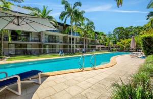 a large swimming pool in front of a building at Rainbow Beach Resort overlooking Pool in Rainbow Beach