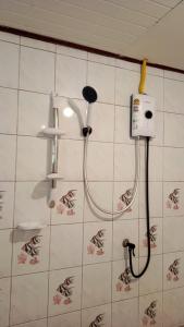 a shower in a bathroom with a blow dryer on a wall at Lanta Diamond in Ko Klang