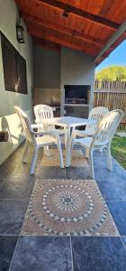 a white table and chairs on a patio at Palmeras del sur in Mar del Plata