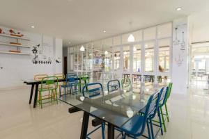 a dining room with a glass table and chairs at RedDoorz Plus @ Vantas Hotel Parbaba in Sinapuran