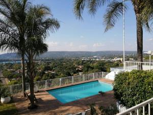 a swimming pool on top of a house at Palm View Guest House in Pretoria