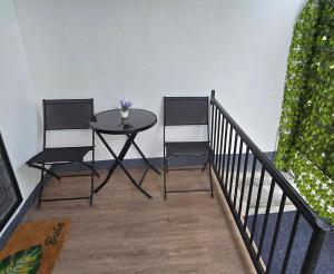 a table and two chairs on a balcony at Kula Nest in Suva +8 photos