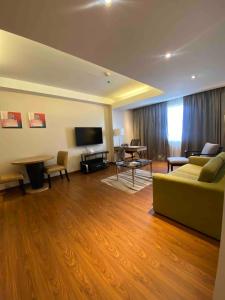 a living room with a couch and a table at ACE Hotel and Suites in Manila