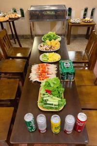 a table with several plates of food on it at Perfume Homestay Huế in Hue