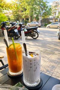 two drinks sitting on a table on the street at Perfume Homestay Huế in Hue +84 photos