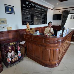 a woman sitting at a counter in a restaurant at Champey Villa in Siem Reap +28 photos