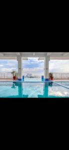 a large swimming pool with a view of a building at Essel s Comfy Place in Manila