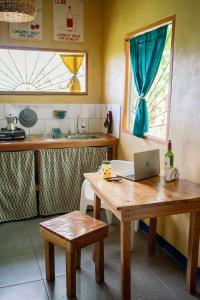 a kitchen with a table with a laptop on it at Finca Aisa -Boutique bungalows in Ometepe island in Santa Cruz