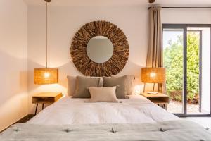 a bedroom with a large bed with a mirror on the wall at Villa Charming House in La Mola +33 photos