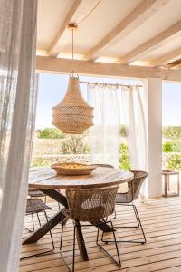 a dining room with a table and chairs at Villa Charming House in La Mola