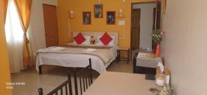 a hotel room with a bed and a table at GLEN RESIDENCY in Chinchinim +25 photos
