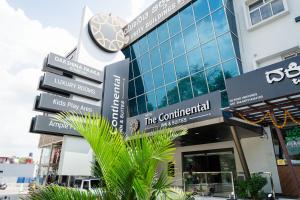 a building with signs in front of it at THE CONTINENTAL INN & SUITES in Mysore