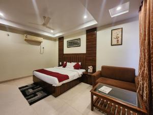 a bedroom with a bed and a couch at Kanta International near katra railway station in Katra