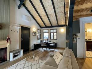 a living room with a couch and a table at Country Charm in Râşnov