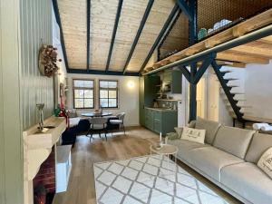 a living room with a couch and a table at Country Charm in Râşnov