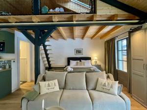 a living room with a couch in front of a bed at Country Charm in Râşnov +81 photos