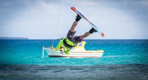 a man is doing a trick on a boat in the water at Fanifo Lofa in Ha’apai