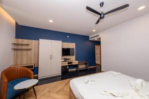 a bedroom with a bed and a ceiling fan at THE CONTINENTAL INN & SUITES in Mysore