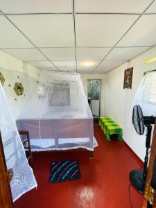 a room with a bed with a mosquito net at Siri Niwasa Sky Villa in Ahangama