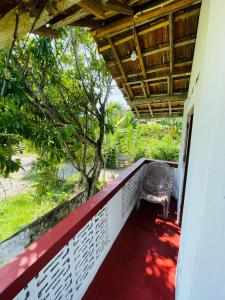 a balcony of a house with a bench on it at Siri Niwasa Sky Villa in Ahangama
