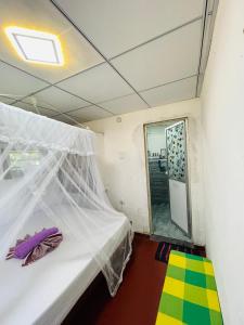 a bedroom with a bed with a mosquito net at Siri Niwasa Sky Villa in Ahangama