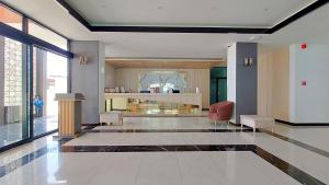 a room with a lobby with a table and chairs at Remas Hotel Hat Yai in Ban Tha Thon +166 photos