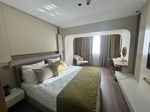 a hotel room with a bed and a desk at Buyuk Saruhan Hotel in Manisa +9 photos