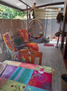 a patio with chairs and a table and a rug at Banian villa in Bora Bora