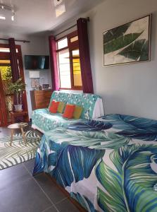 a bedroom with two beds and a couch at Banian villa in Bora Bora