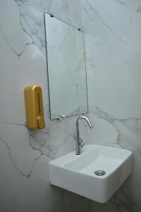 a bathroom with a sink and a mirror on a wall at Hotel aditya palace in Padrauna