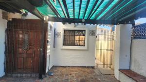 an entrance to a house with a blue ceiling at Casa Jardines in Mexicali