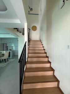 a staircase in a house with wooden floors at Villa SRC in Sungai Petani