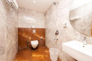 a bathroom with a sink and a toilet at THE CONTINENTAL INN & SUITES in Mysore +41 photos