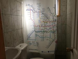 a bathroom with a map on the wall next to a toilet at Cabañas en Algarrobo Norte in Algarrobo