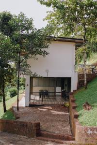 a house with a porch and a patio at Camplights Stays in Tariyod