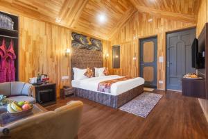 a hotel room with a bed and a couch at Hotel Classy Castle in Kolur +19 photos