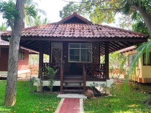 a small red house with a porch and a tree at Bayview Beach Resort in Ban Krut +37 photos
