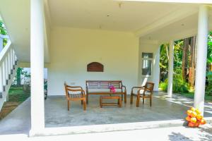 a patio with a table and four chairs at Abhimani Bungalows in Aluthgama +59 photos