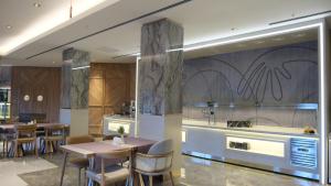 a restaurant with tables and chairs and a kitchen at Buyuk Saruhan Hotel in Manisa