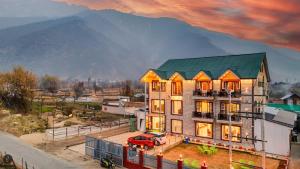 a building with a red truck parked in front of it at Hotel Classy Castle in Kolur